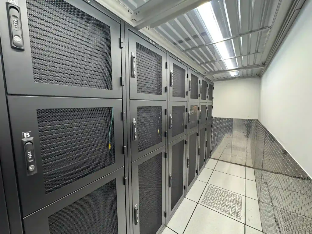 Quarter and half cabinets secured with combination locks beside a caged area in a Miami data center